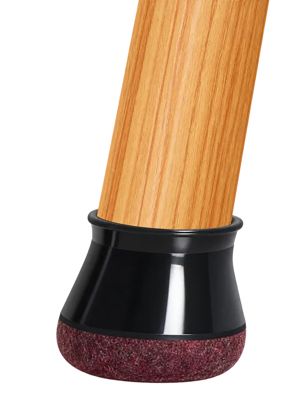 Black felt-bottom protector fitted on a wooden chair leg